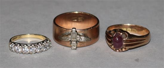 Three 9ct gold rings, one set with red cabochon.